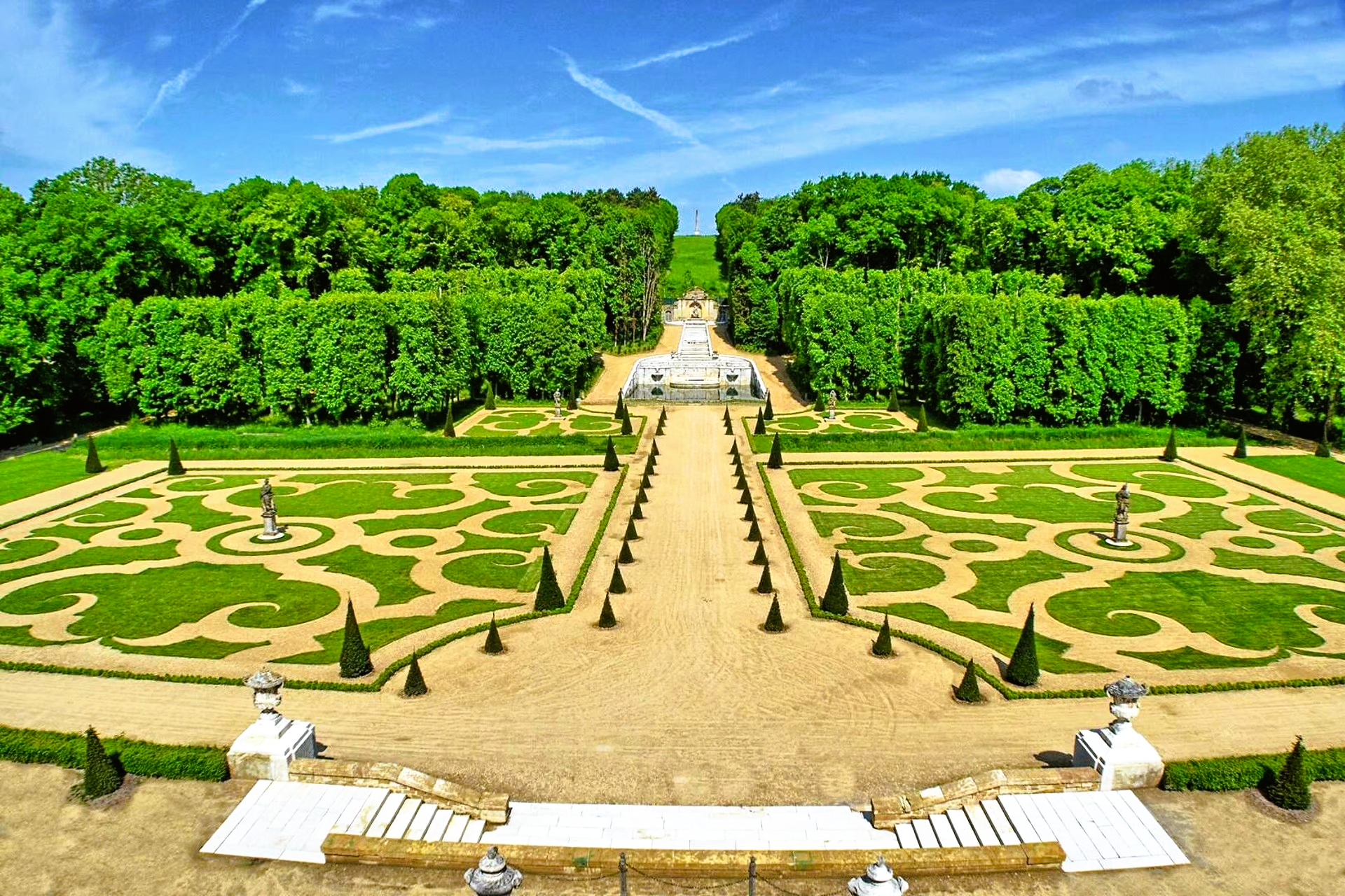 A large garden with a lot of trees in the background