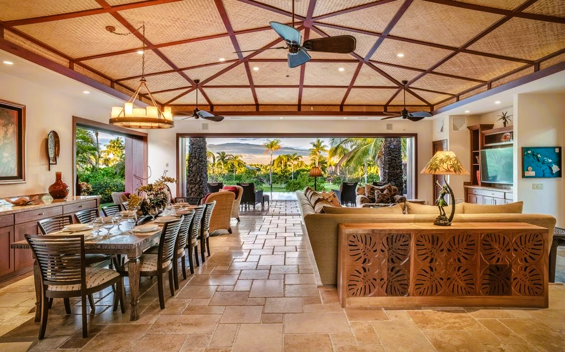 Open-concept living and dining room with a view. Beige, neutral colors, vaulted ceiling. Dining table and lounge area.