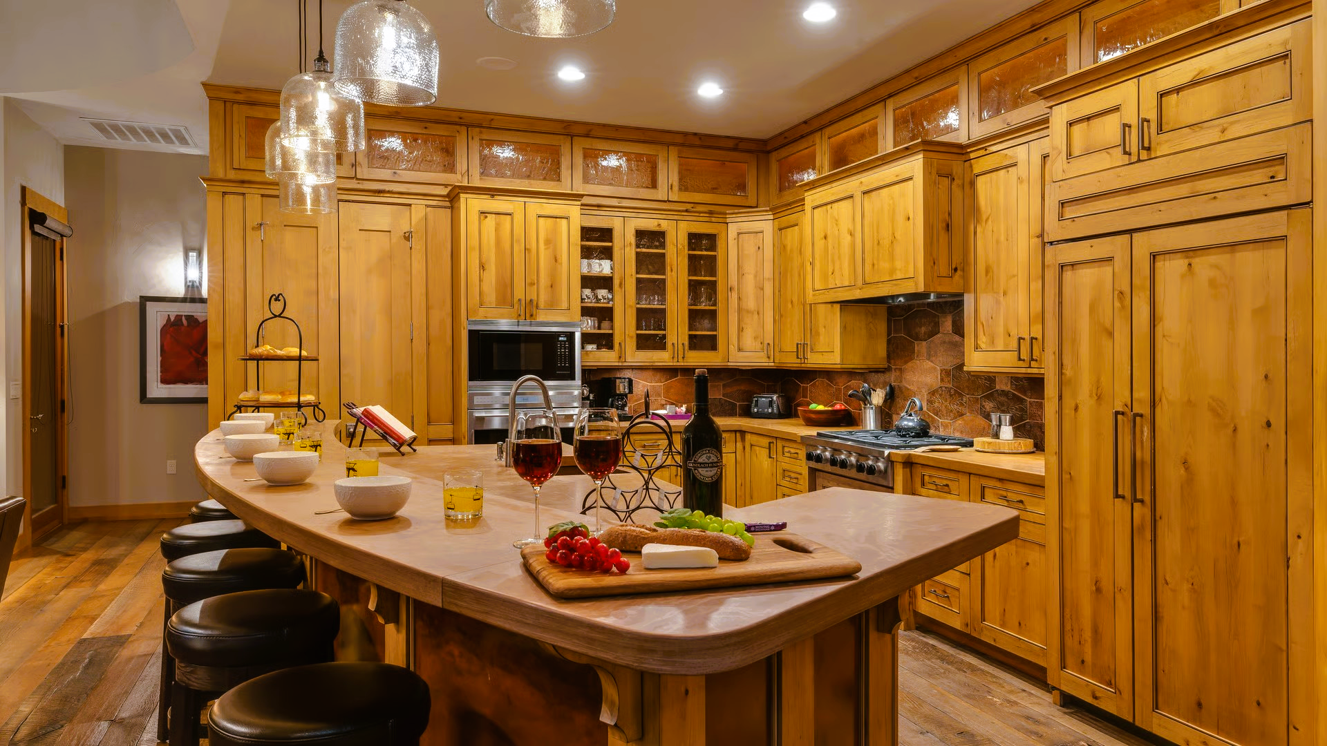 Rustic kitchen with wood cabinets, an island bar, and a wine setup.