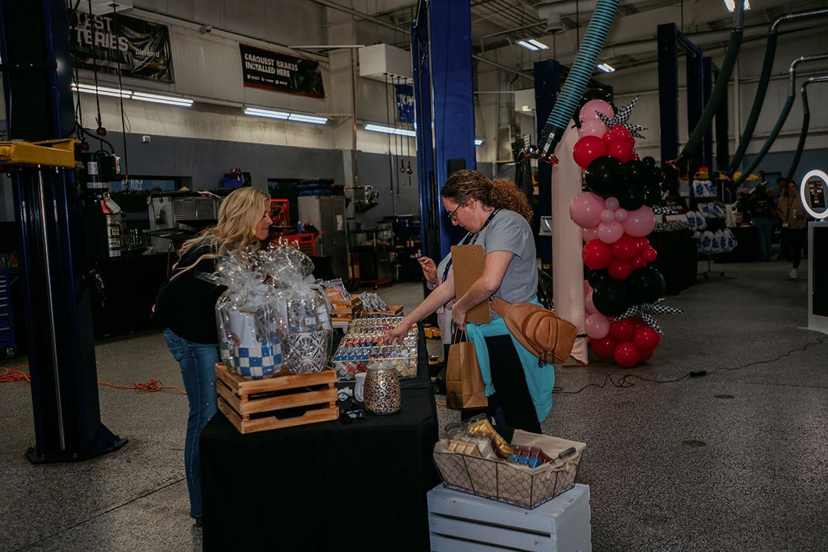 Two ladies browsing through trinkets in our shop during Ladies Night | Full Throttle Automotive LLC