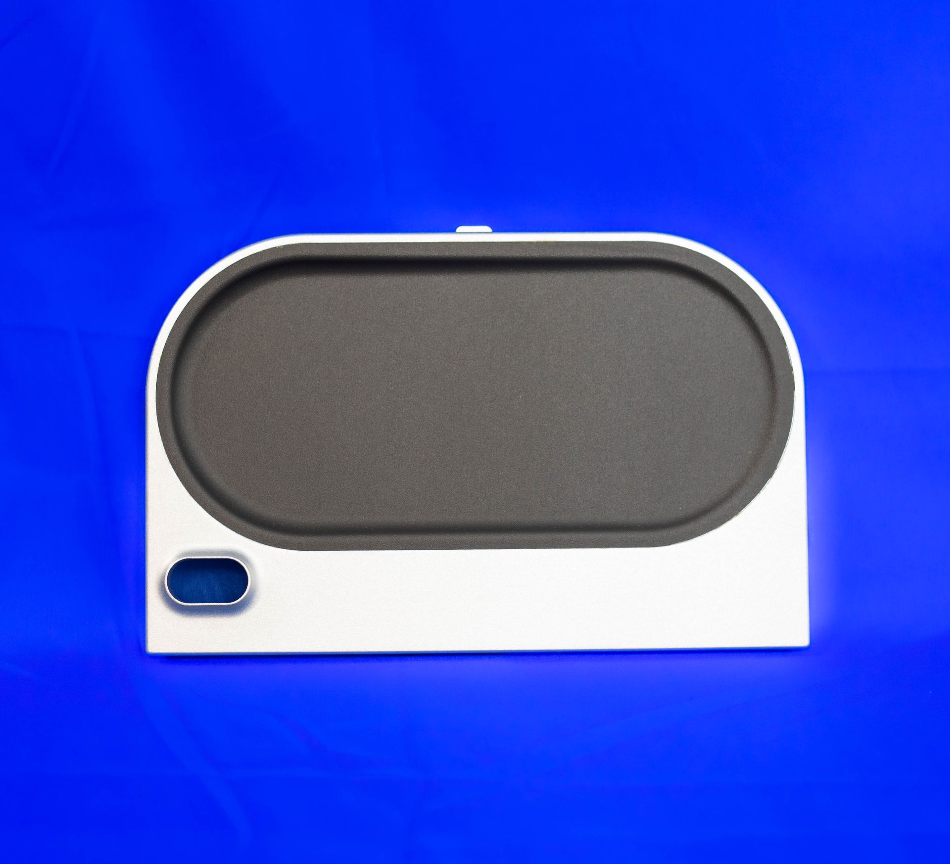 A gray and white item with a blue button on it