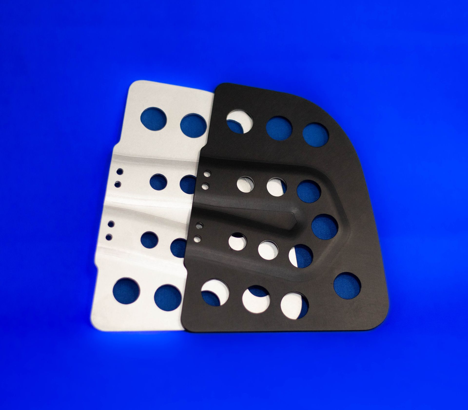 A black and white piece of metal on a blue surface