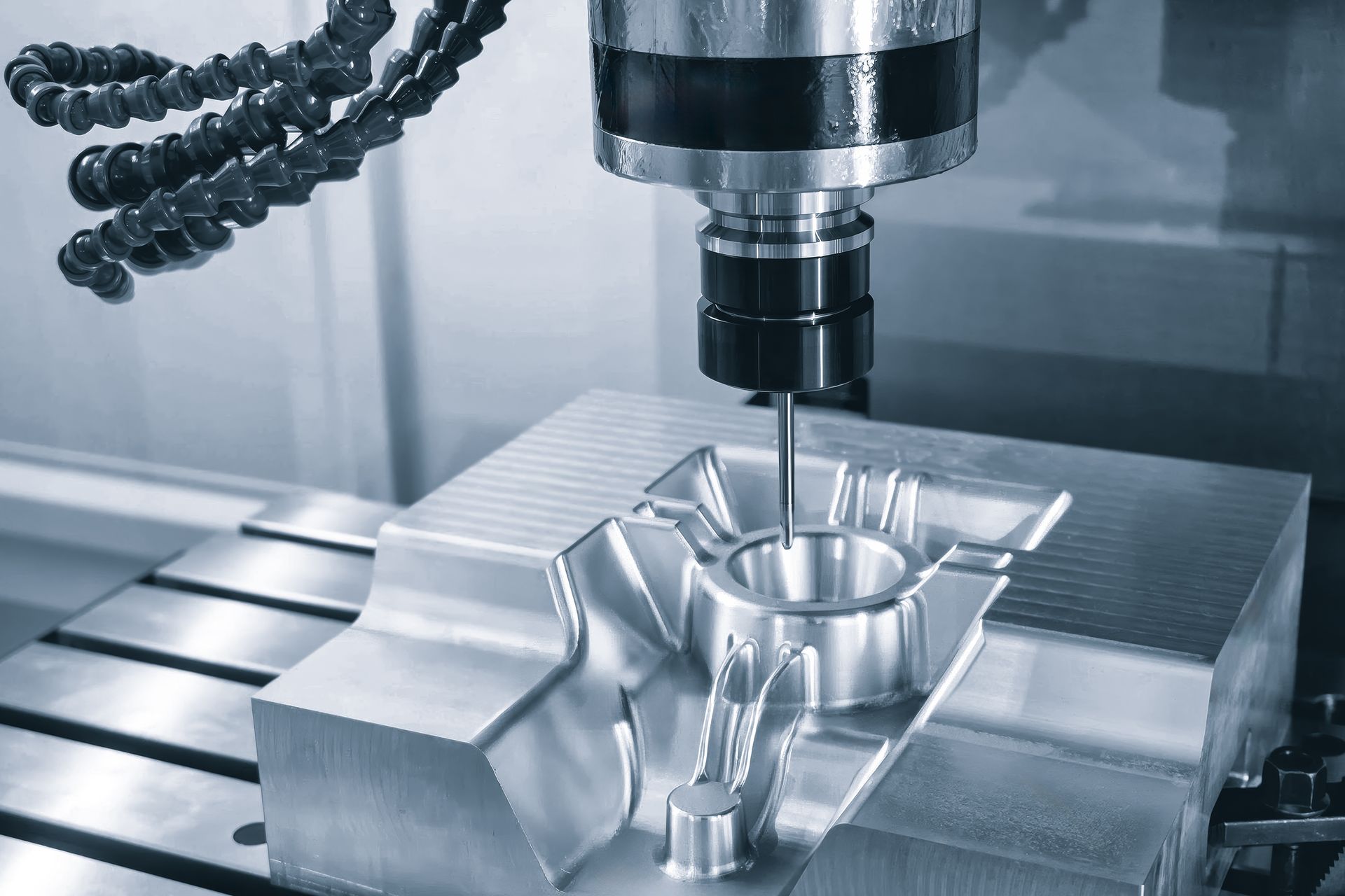 A machine is cutting a piece of metal on a table.