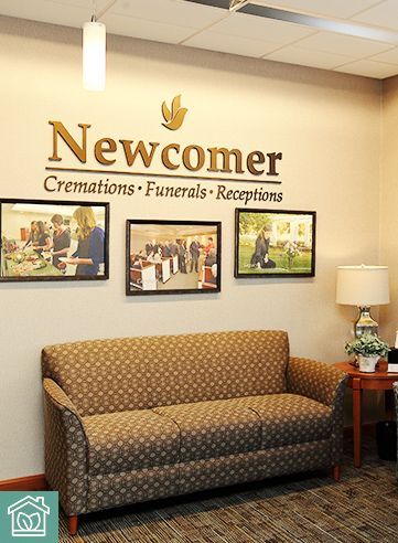 Lobby with couch, framed photos, and gold 