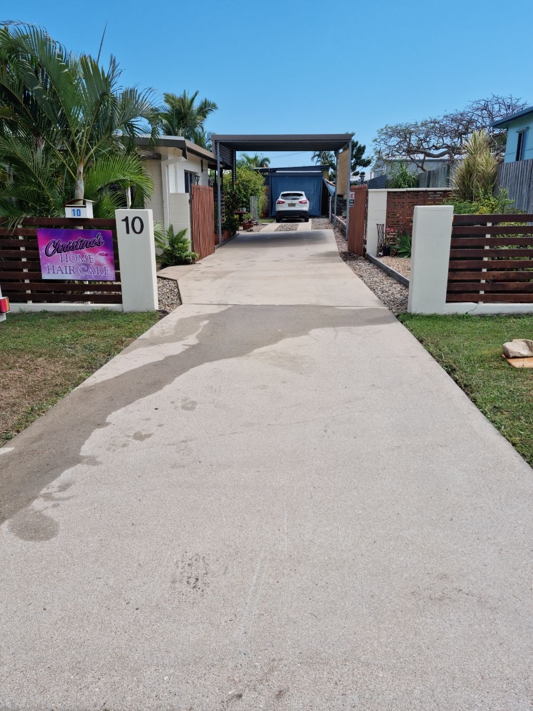 A Person is Using a High Pressure Washer to Clean a Concrete Floor — Blast H2O In Proserpine, QLD