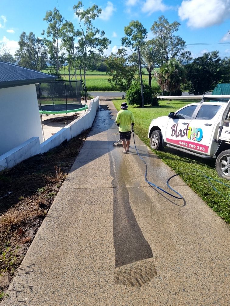 A Person is Cleaning a Wooden Table With a High Pressure Washer — Blast H2O In Proserpine, QLD