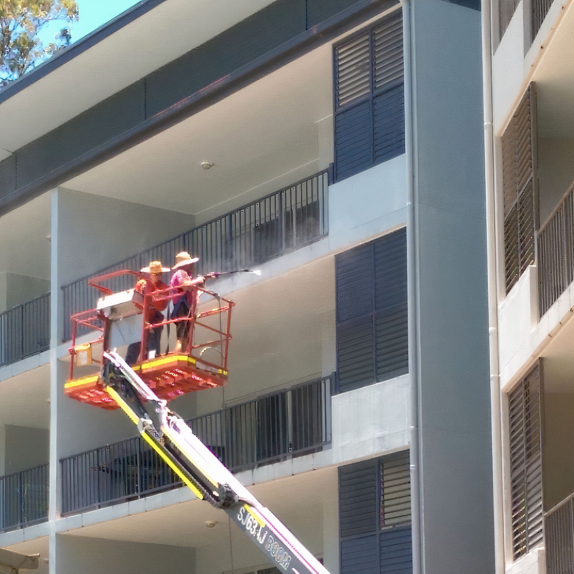 A Person is Using a High Pressure Washer to Clean a Concrete Floor — Blast H2O In Airlie Beach, QLD