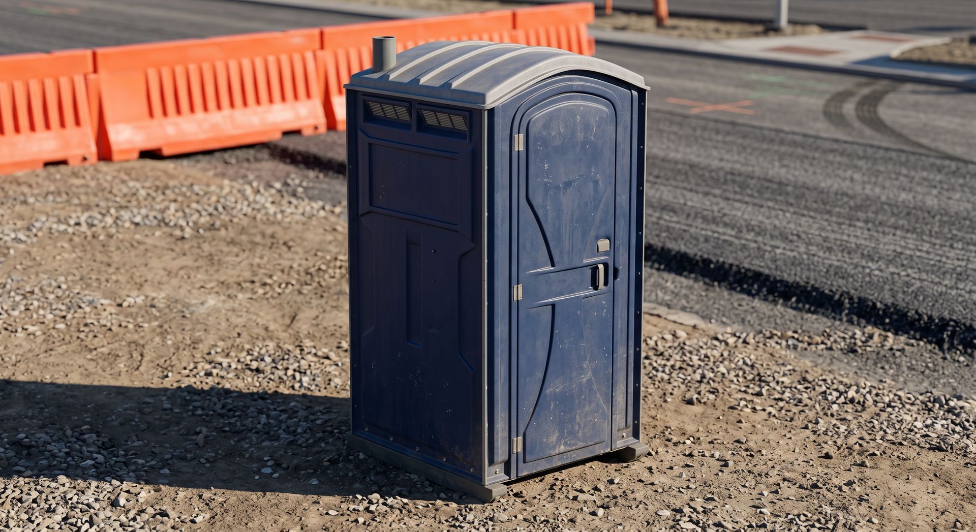 Worker unloads blue portable toilets from a truck near a beach house.