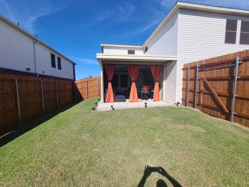 Backyard patio with orange curtains