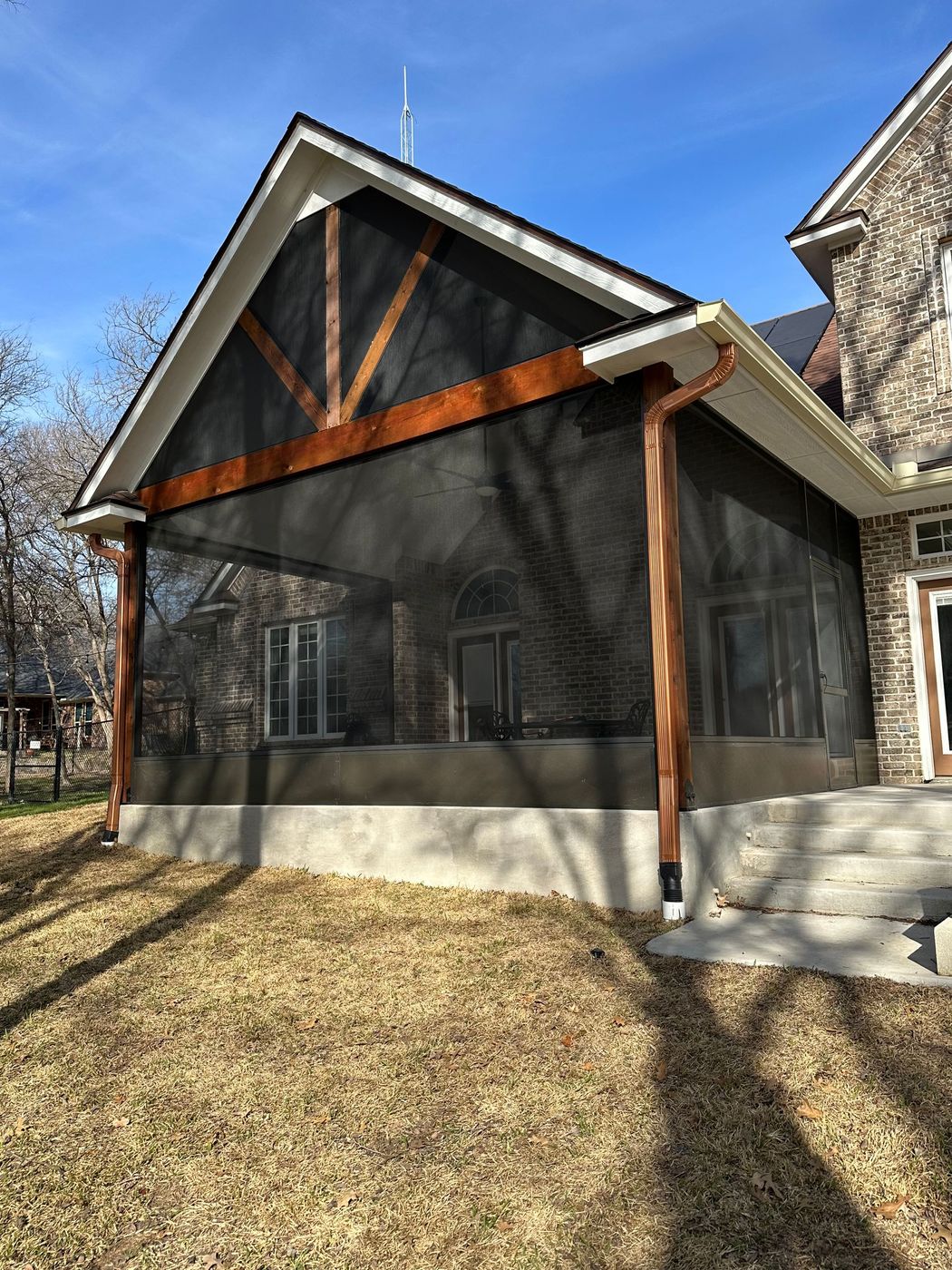 Screened-in porch with wood trim