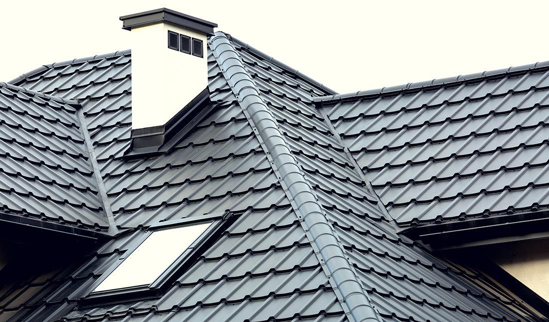 A Roof With a Chimney and Two Skylights on It  — East Coast Roof Tiling Services in Maroochydore, QLD
