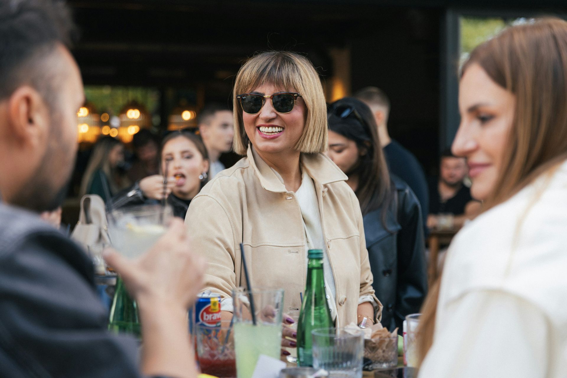 Networking event; female in sunglasses smiling at camera