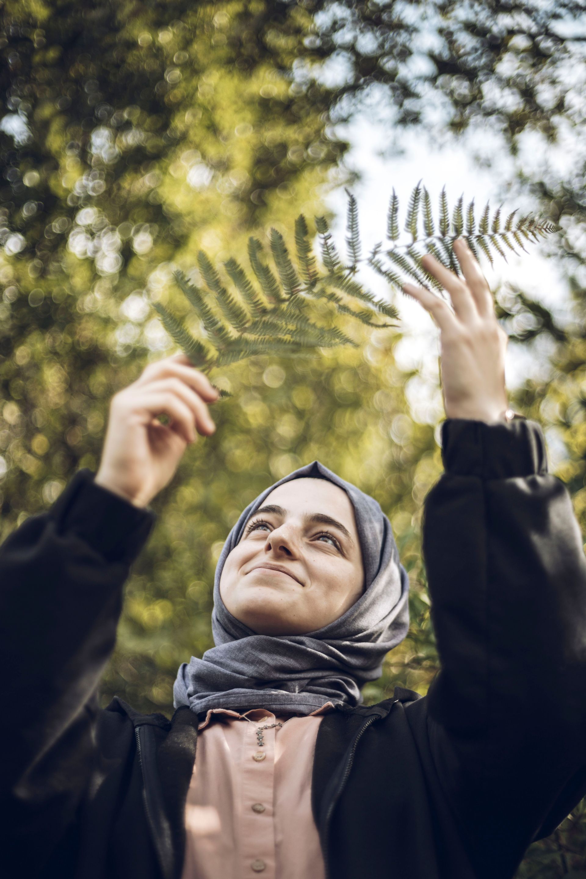 person with dirt in one hand and plant in the other