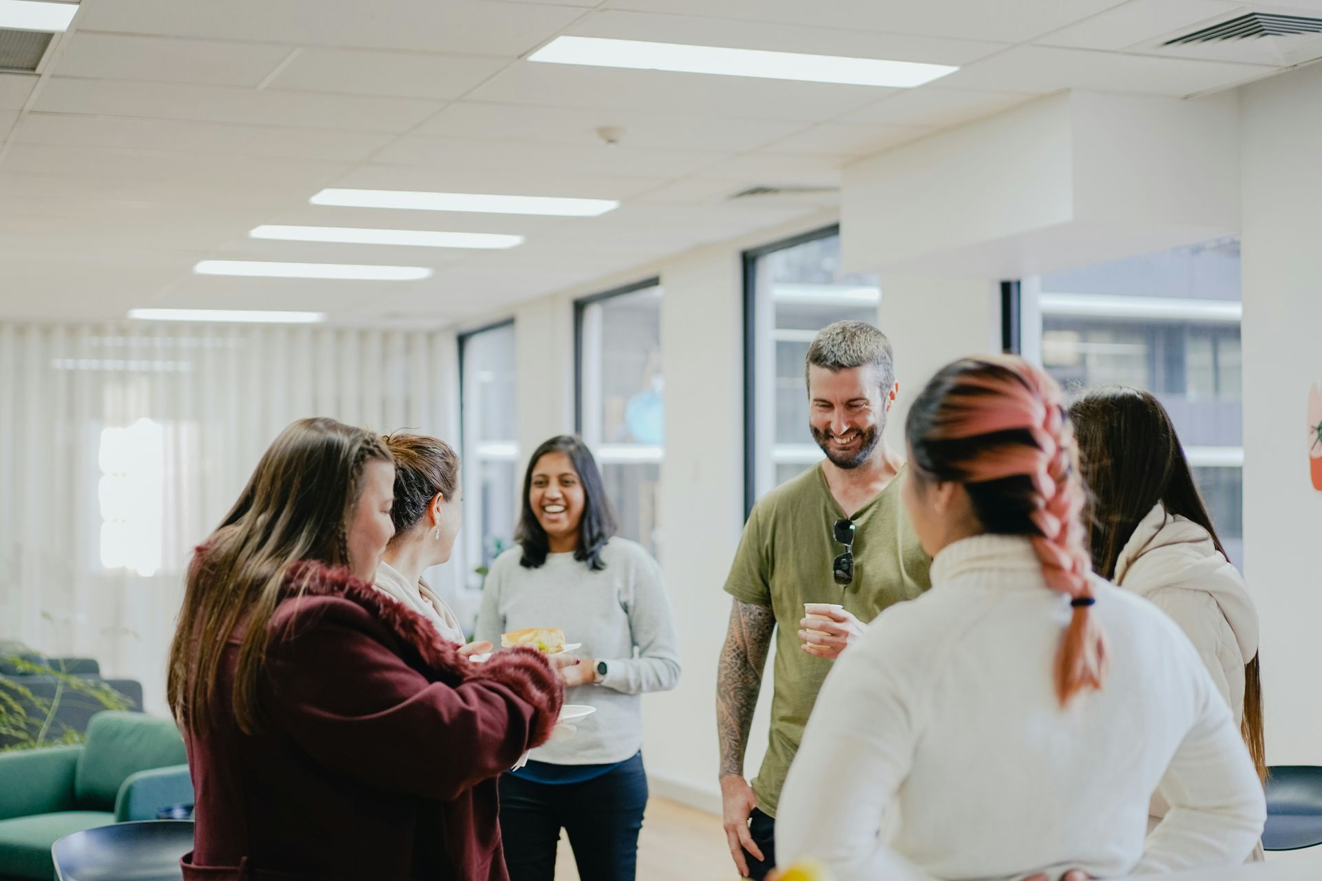 People in circle laughing and smiling