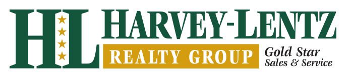 The harvey lentz realty group logo is green and gold