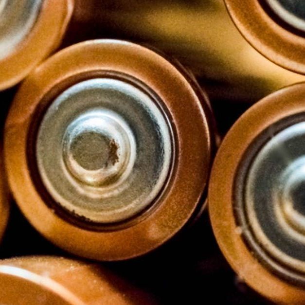 A bunch of batteries are stacked on top of each other