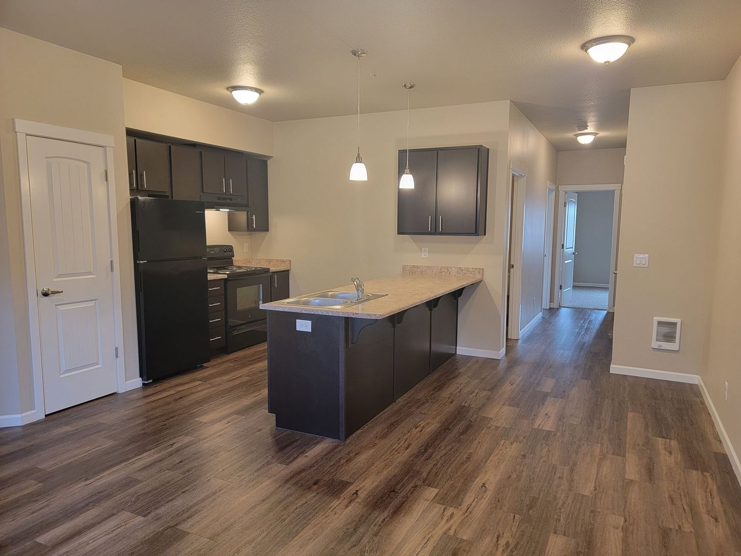 A kitchen with a large island in the middle of the room.