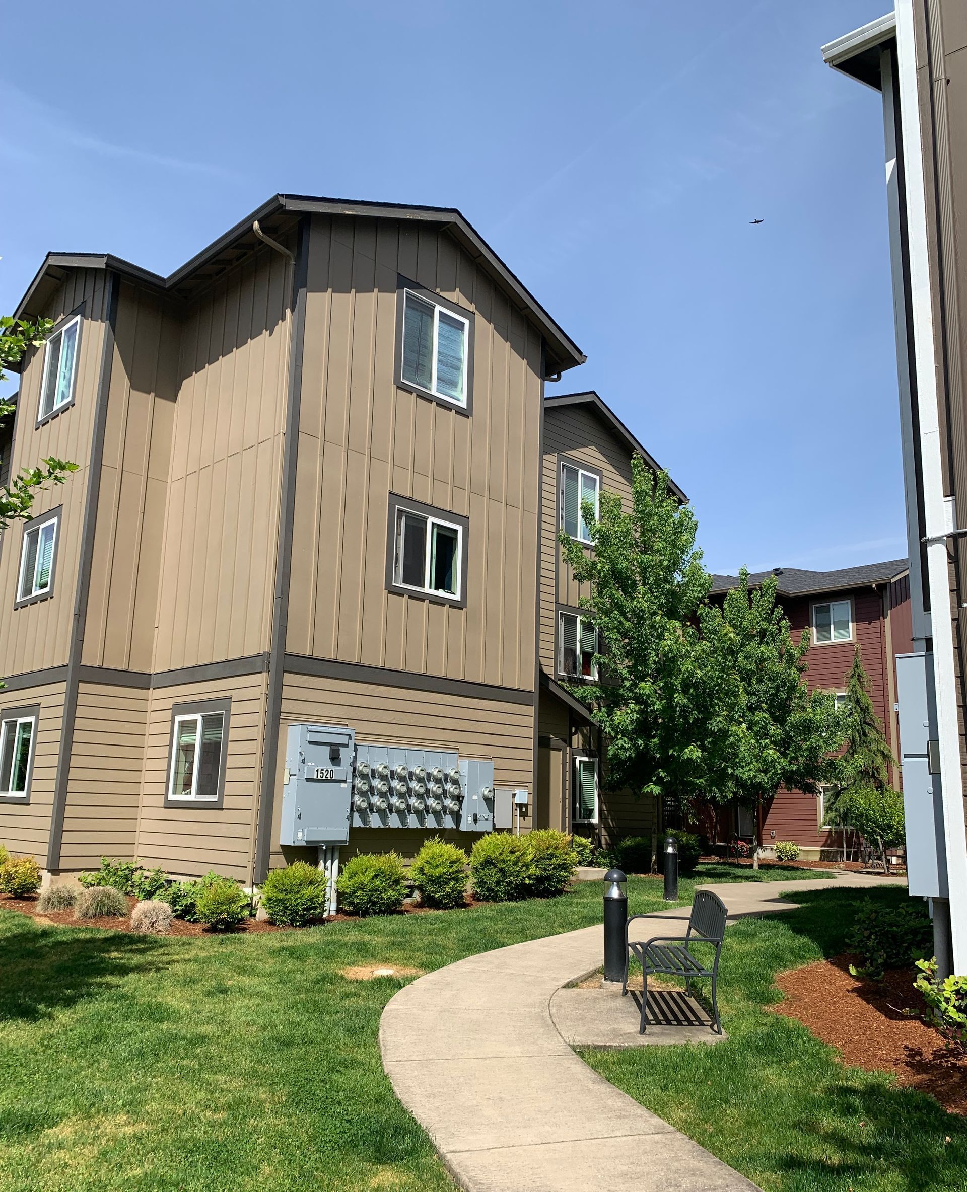 A large apartment building with a walkway leading to it