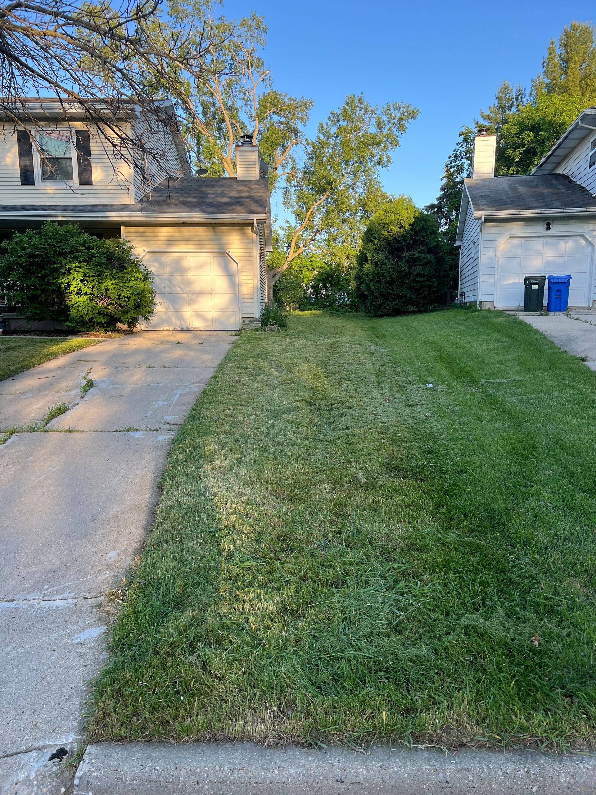 A house with a lush green lawn in front of it.