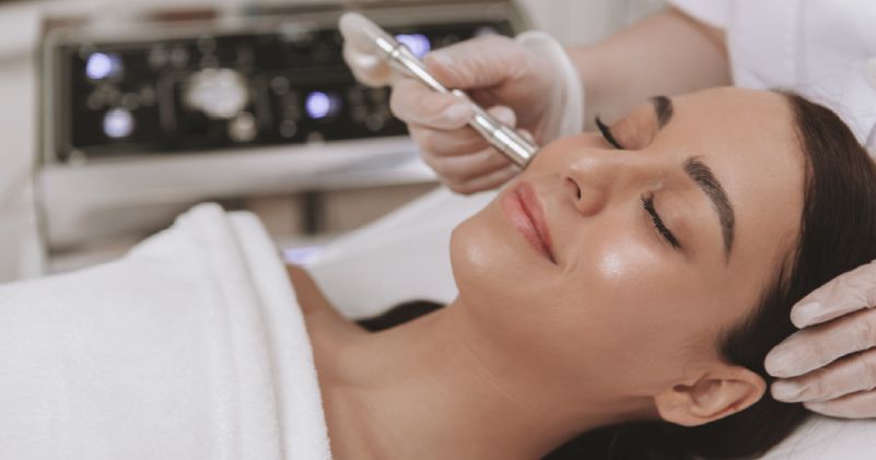 A woman is getting a facial treatment in a beauty salon.