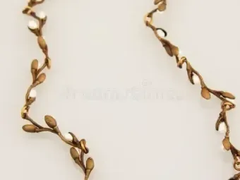 Gold vine-like decorative border on a beige background