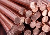 Stacked copper pipes with shiny ends in a close-up view