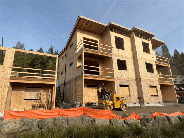 A building under construction with a forklift in front of it