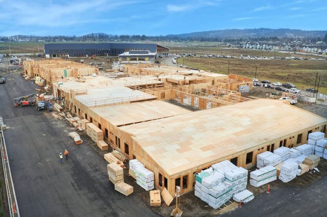 An aerial view of a large wooden building under construction.
