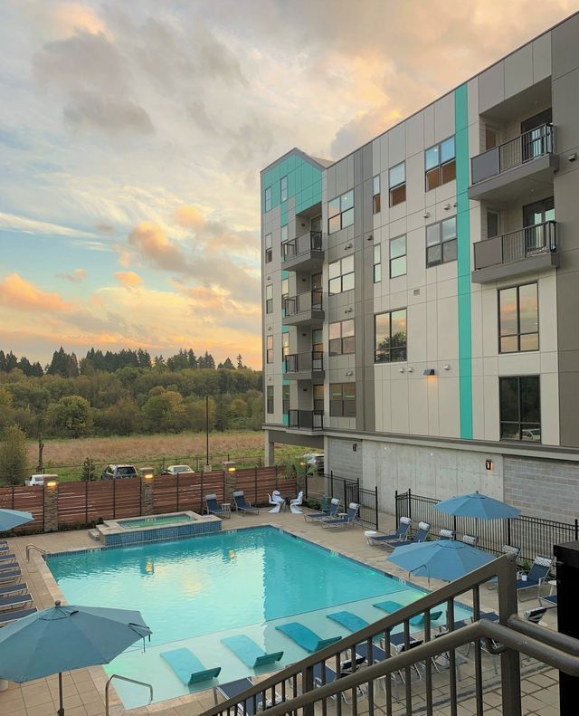 A large building with a swimming pool in front of it