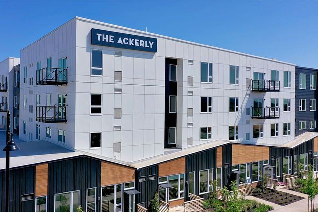 The ackerly is a large apartment building with a lot of windows.
