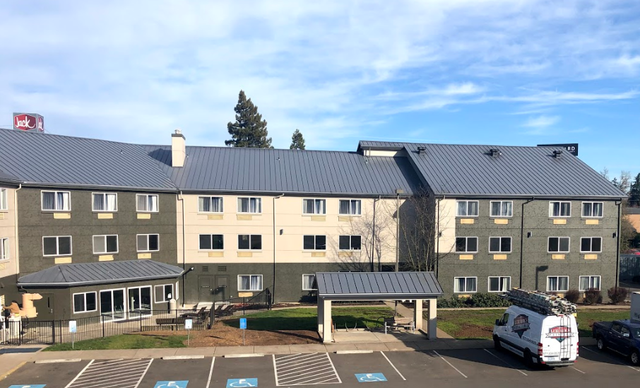 A large building with a van parked in front of it