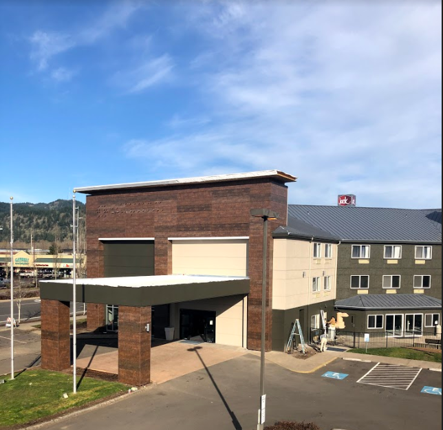 A large brick building with a parking lot in front of it