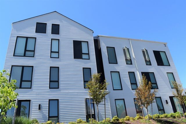 A large white building with a blue sky in the background