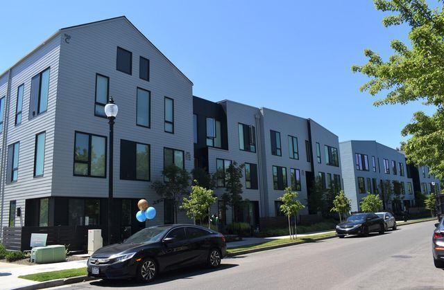 A black car is parked in front of a building