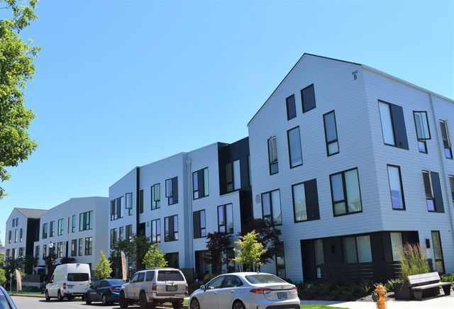 A white building with cars parked in front of it