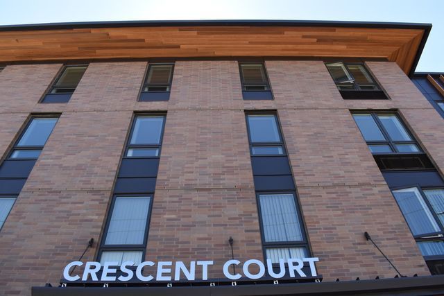 A large brick building with a sign that says crescent court