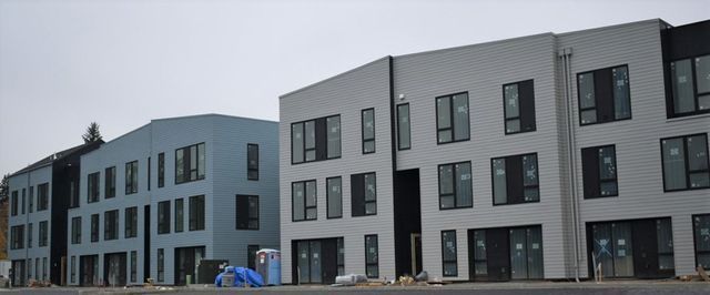 A row of buildings are being built in a city.