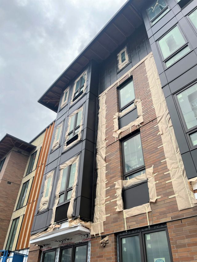 A large building with a lot of windows is being built.