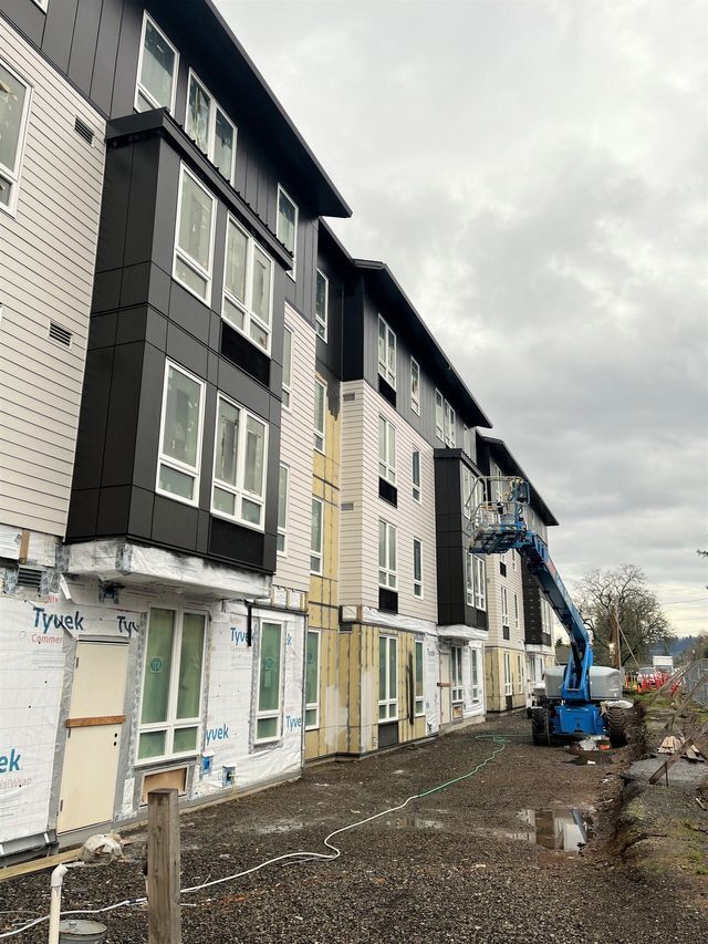 A large apartment building under construction with a lot of windows.
