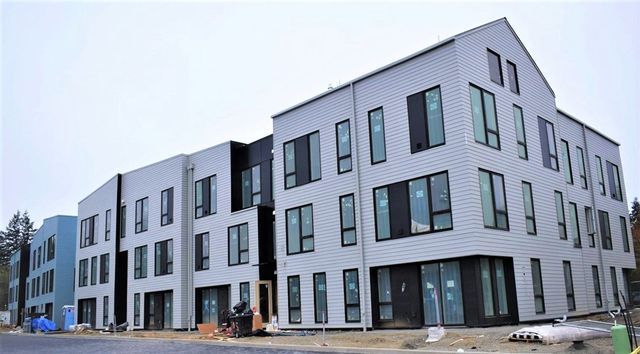 A large building with a lot of windows is under construction.
