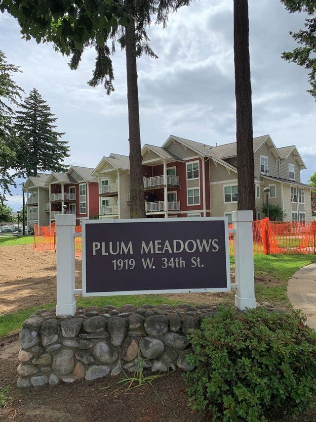 A plum meadows sign in front of a building