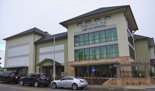 A storage building with cars parked in front of it