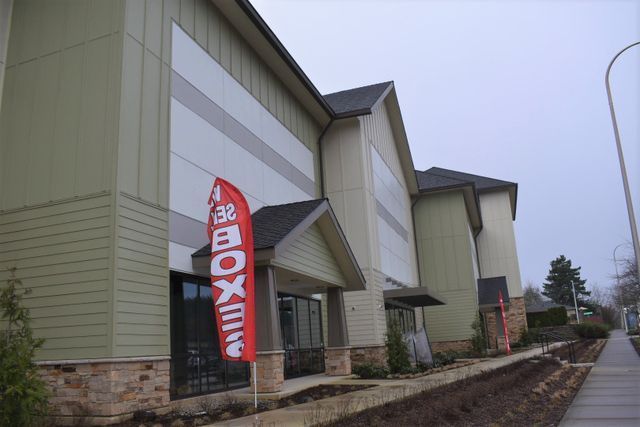 A large building with a red flag that says box on it
