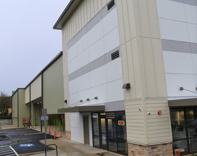 A large building with a parking lot in front of it
