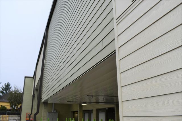 A large white building with a lot of siding on it