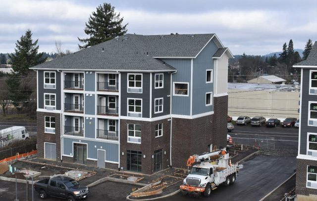 A truck is parked in front of a building under construction