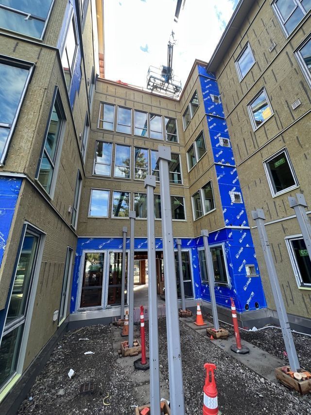 A large building under construction with a crane on top of it