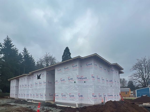 A large building is being built in the middle of a forest.