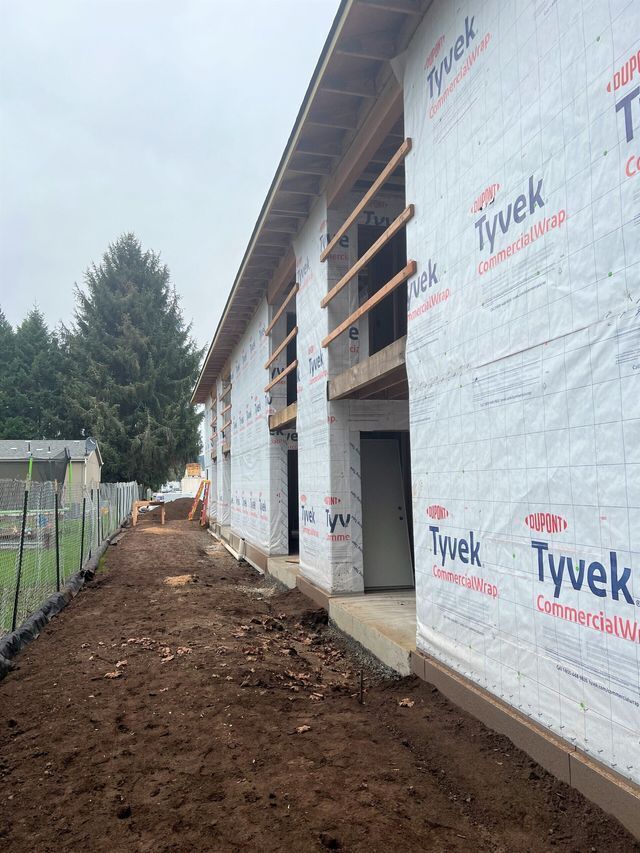 A building under construction with a lot of styrofoam on the side of it.