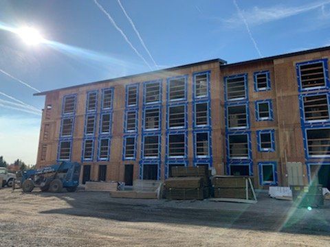 A large building under construction with a lot of windows.